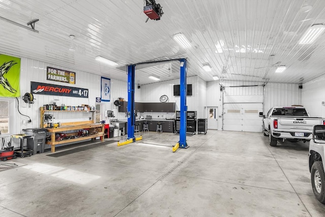 garage with a workshop area and a garage door opener