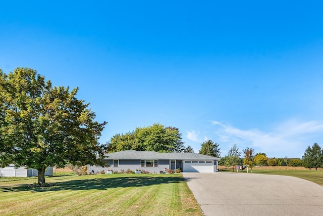 ranch-style house featuring a front yard and a garage