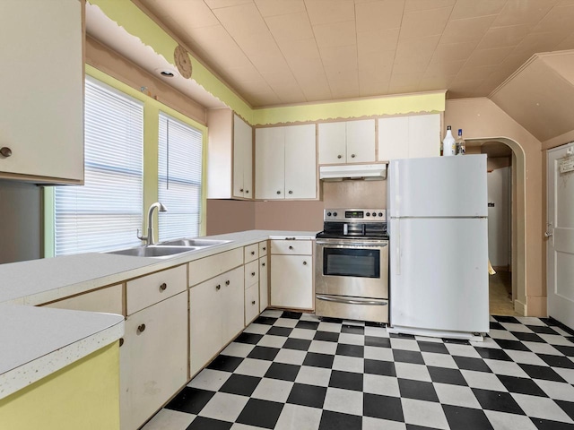 kitchen featuring stainless steel range with electric stovetop, white refrigerator, white cabinets, and sink