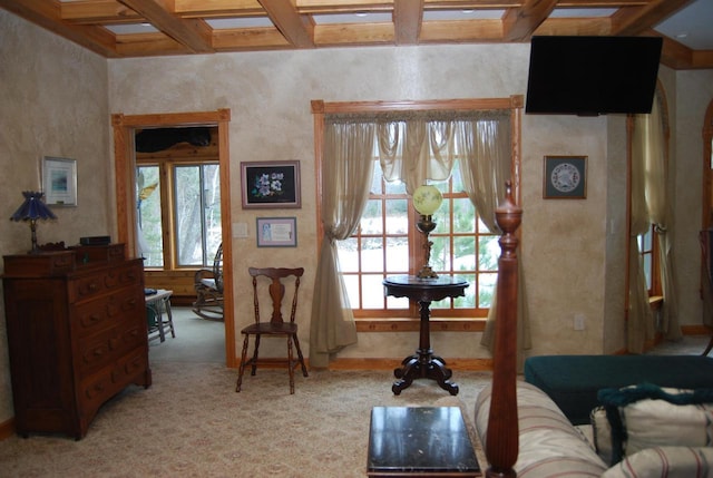 living area with beamed ceiling, light carpet, and coffered ceiling