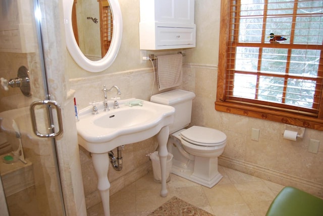 bathroom featuring tile patterned flooring, toilet, tile walls, and walk in shower