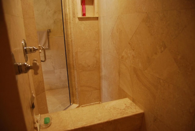 bathroom with tiled shower