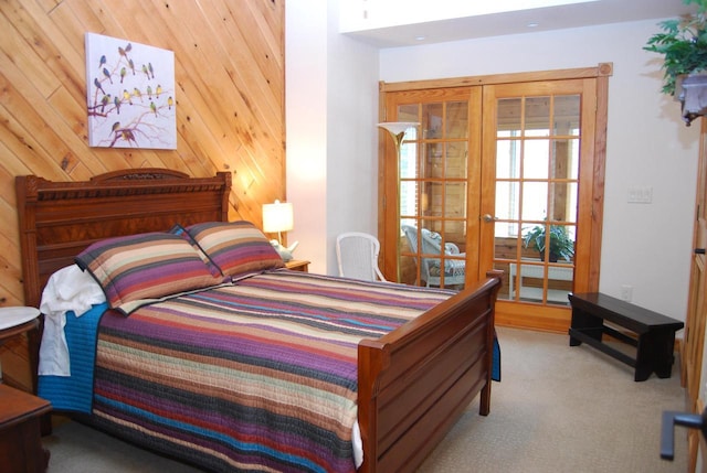 carpeted bedroom featuring wooden walls