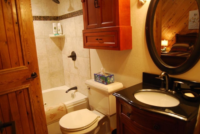 full bathroom with vanity, tiled shower / bath combo, and toilet