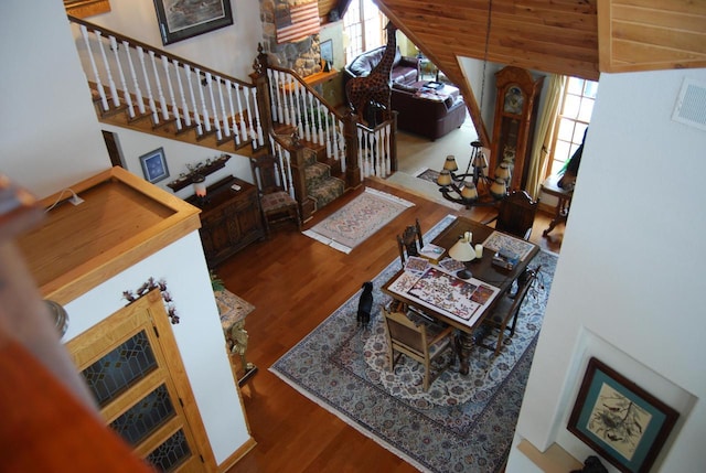 living room with hardwood / wood-style flooring and high vaulted ceiling