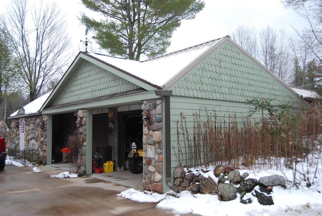 view of snowy exterior with a garage