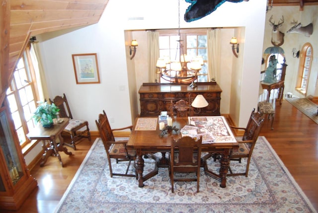 dining room with light hardwood / wood-style floors and an inviting chandelier