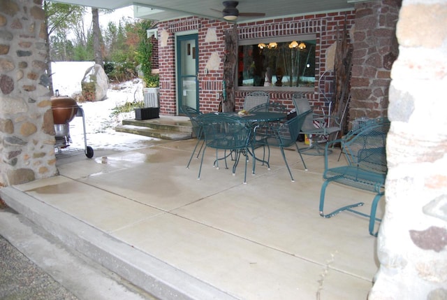 snow covered patio with ceiling fan