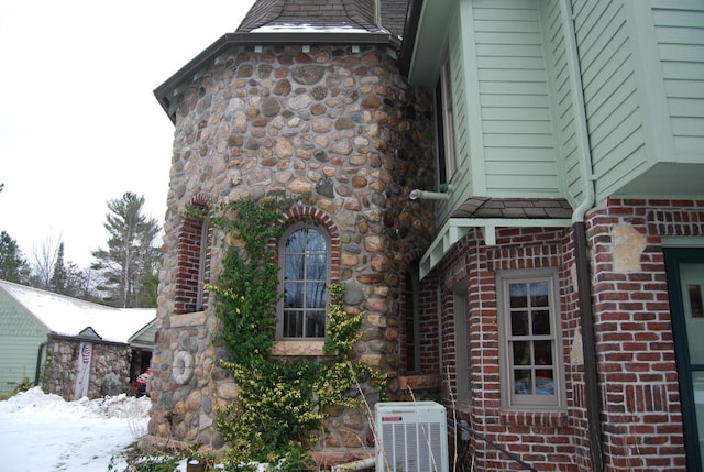 view of snow covered exterior with central air condition unit