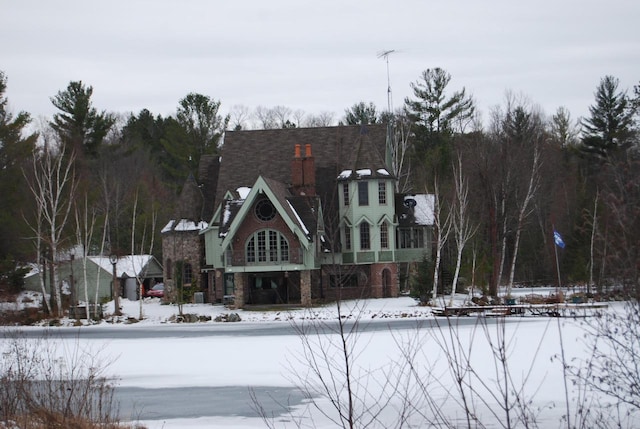 view of snow covered back of property