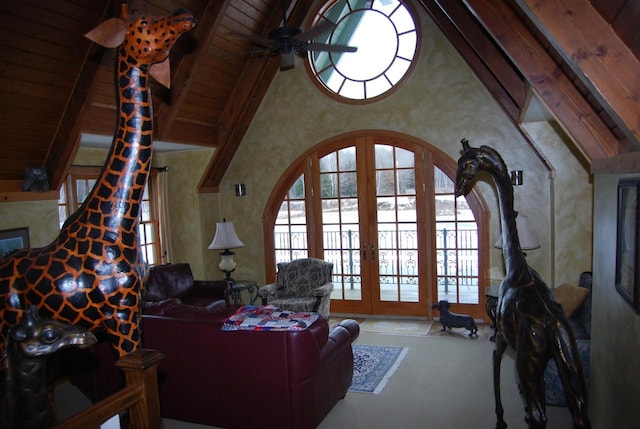 living room with vaulted ceiling with beams, ceiling fan, french doors, and wood ceiling