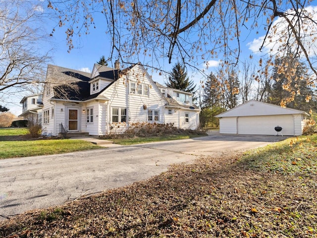 view of side of property featuring a garage and an outdoor structure