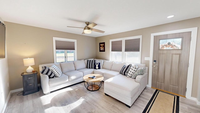 living room featuring ceiling fan and light wood-type flooring