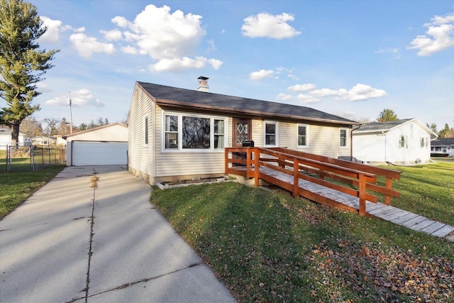 view of front of house featuring an outdoor structure, a garage, a wooden deck, and a front yard