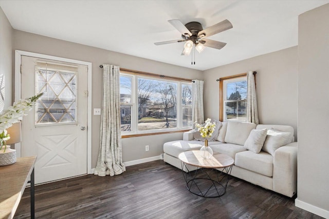 living room with dark hardwood / wood-style floors, ceiling fan, and a wealth of natural light