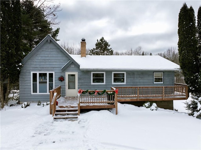 snow covered property featuring a deck