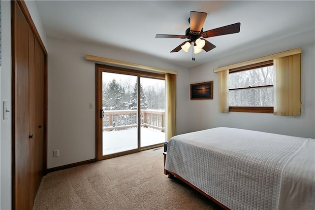 bedroom featuring ceiling fan, access to exterior, light colored carpet, and multiple windows