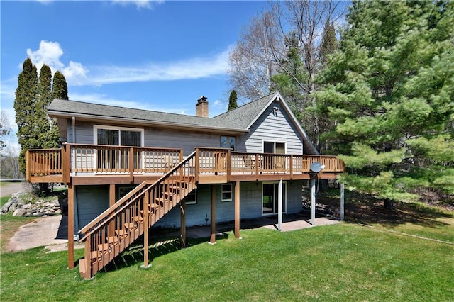 back of property with a yard and a wooden deck