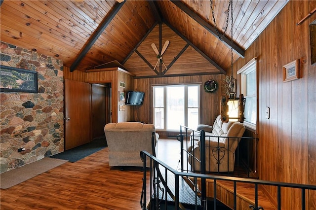 dining area with beamed ceiling, dark hardwood / wood-style floors, wooden ceiling, and wood walls