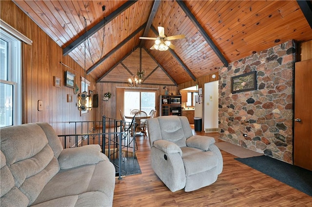 living room with wood ceiling, hardwood / wood-style flooring, high vaulted ceiling, beamed ceiling, and wood walls