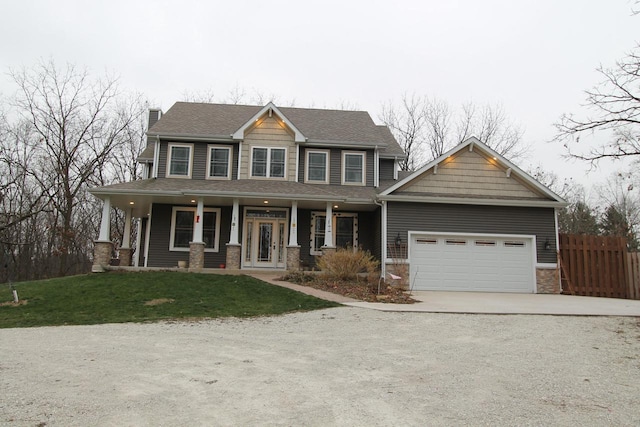 craftsman house featuring covered porch, a garage, and a front yard