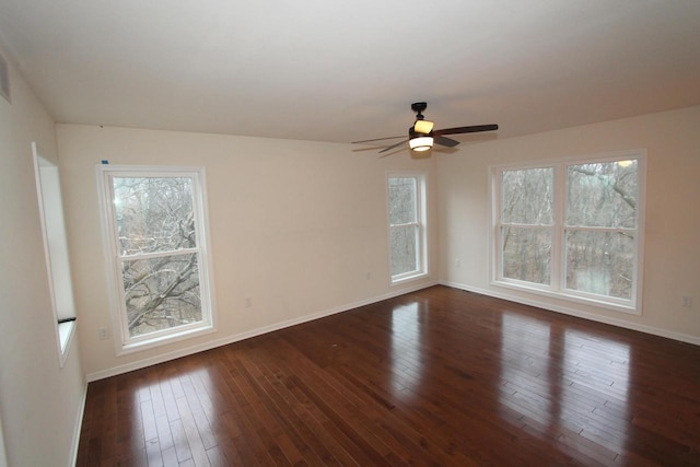 empty room with ceiling fan and dark wood-type flooring