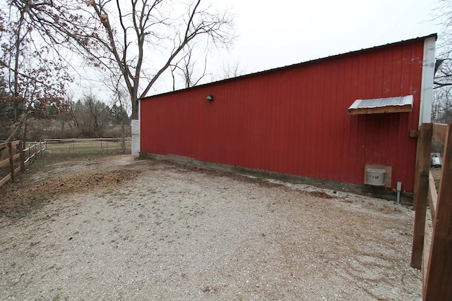 view of property exterior with an outbuilding