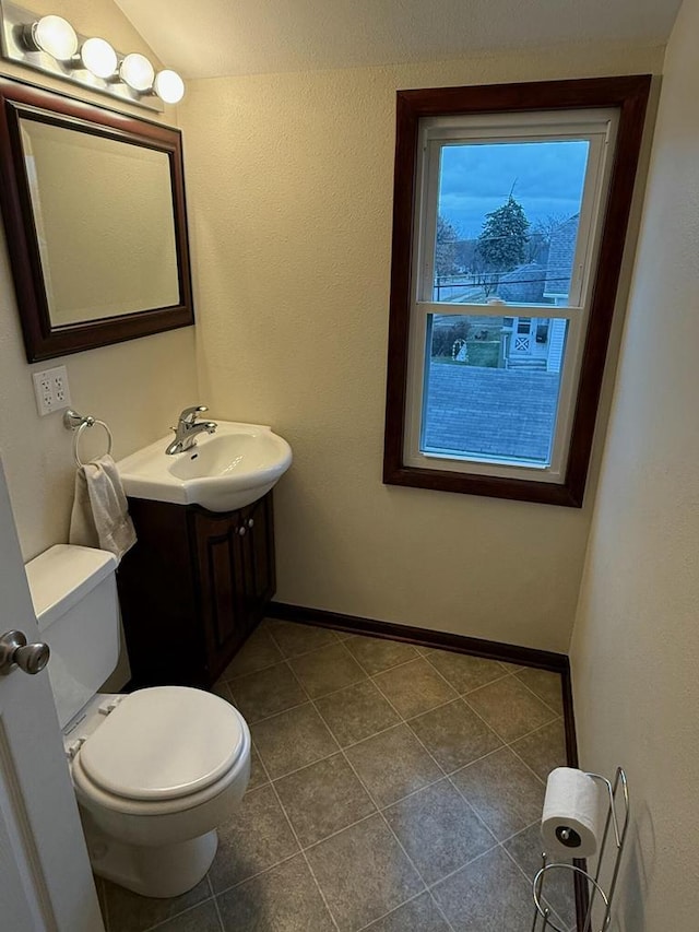 bathroom with tile patterned flooring, vanity, and toilet