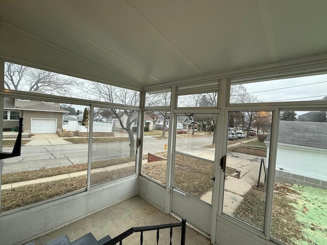 unfurnished sunroom featuring a healthy amount of sunlight and lofted ceiling