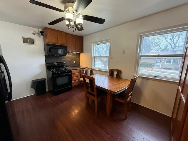 dining area featuring ceiling fan and dark wood-type flooring