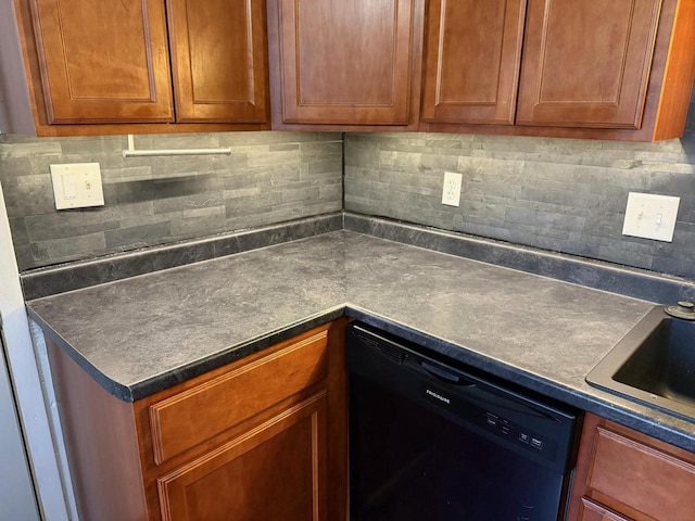 kitchen featuring backsplash, dishwasher, and sink