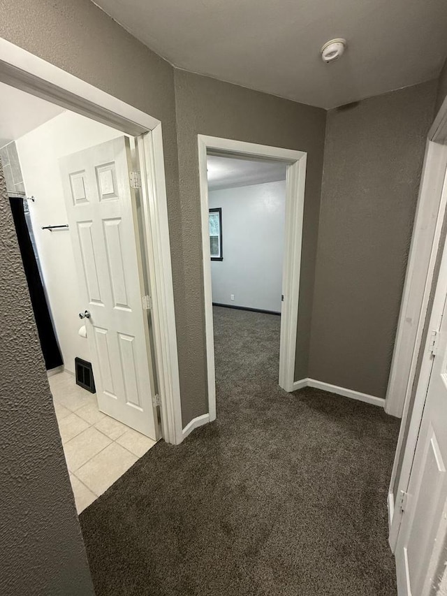 hallway with light colored carpet