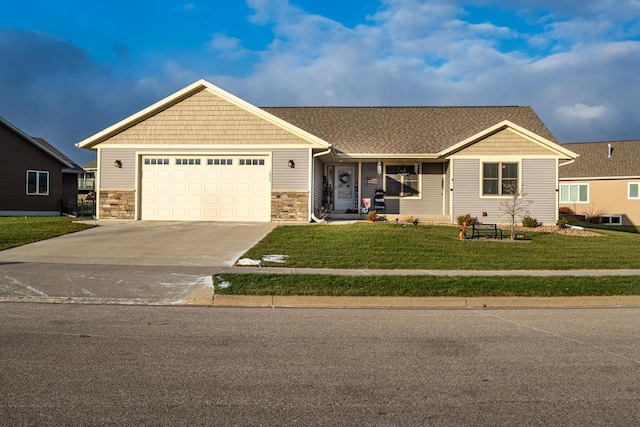 view of front of property with a front yard and a garage