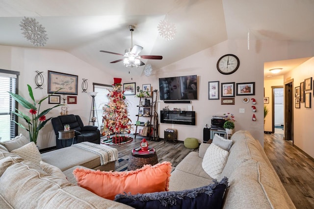 living room featuring wood-type flooring, vaulted ceiling, and ceiling fan