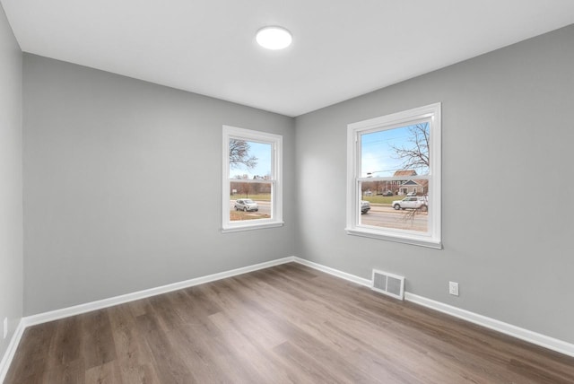 unfurnished room featuring hardwood / wood-style flooring