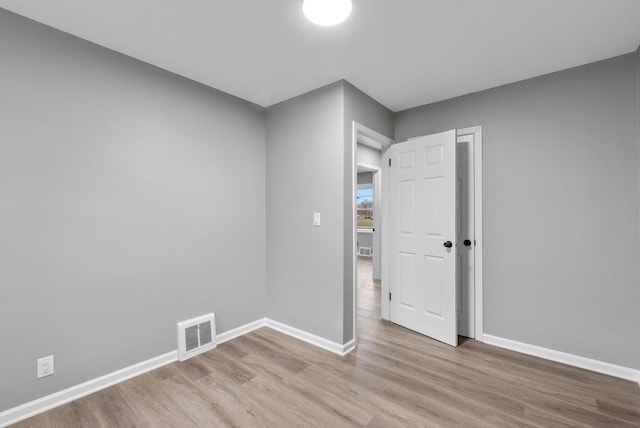 unfurnished room with light wood-type flooring