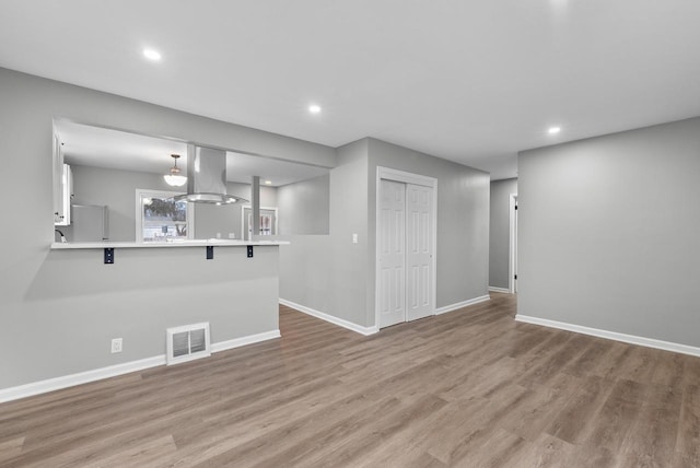 unfurnished living room with light hardwood / wood-style flooring