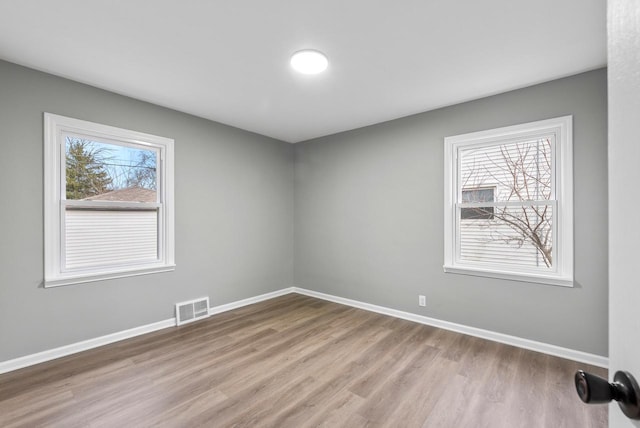 unfurnished room with light wood-type flooring