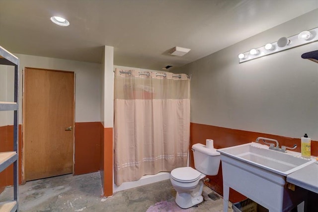 full bathroom featuring vanity, toilet, concrete flooring, and shower / tub combo with curtain