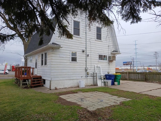 rear view of house featuring a yard and a patio area