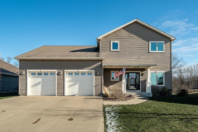 view of front of house featuring a garage and a front lawn