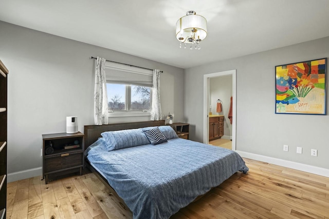 bedroom featuring hardwood / wood-style flooring and ensuite bath