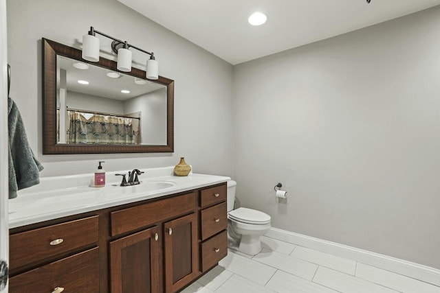 bathroom with tile patterned flooring, vanity, and toilet