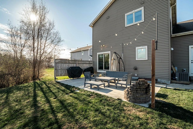 rear view of house with cooling unit, a patio area, and a lawn