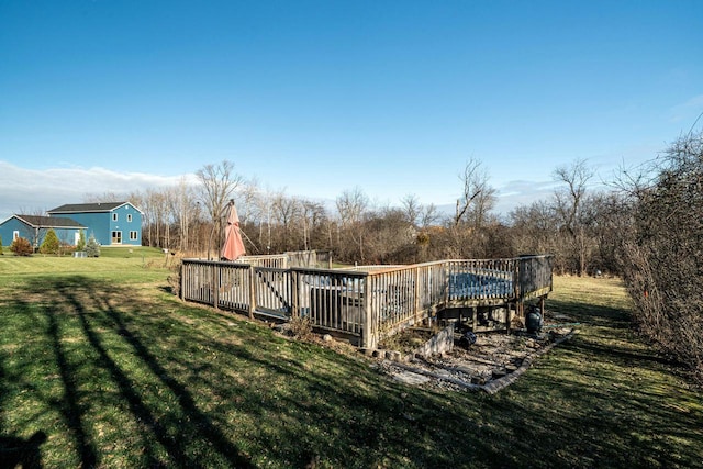 view of swimming pool featuring a yard and a deck