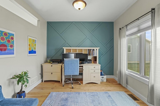 office space featuring light hardwood / wood-style floors and a wealth of natural light