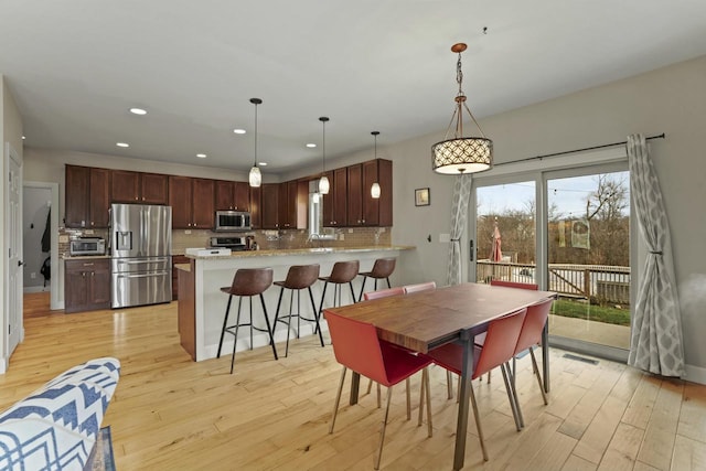 dining area with light hardwood / wood-style flooring