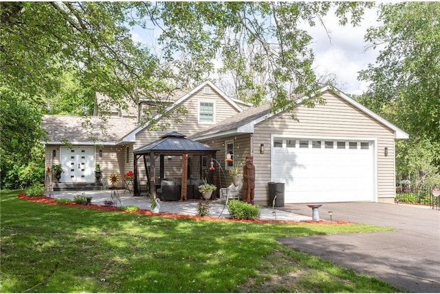 view of front of house featuring a gazebo, a front yard, and a garage