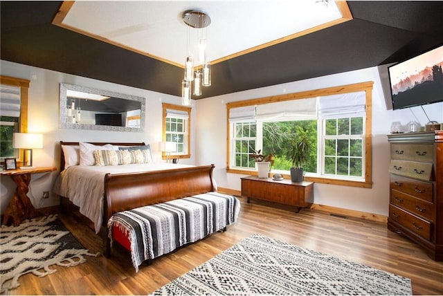 bedroom with hardwood / wood-style flooring and lofted ceiling