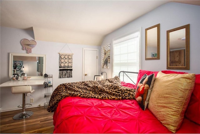 bedroom featuring wood-type flooring and vaulted ceiling